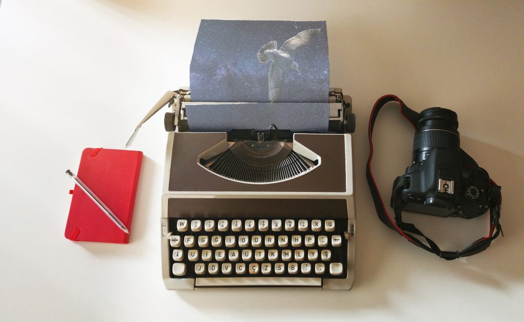 Book with pen, Type writer and camera