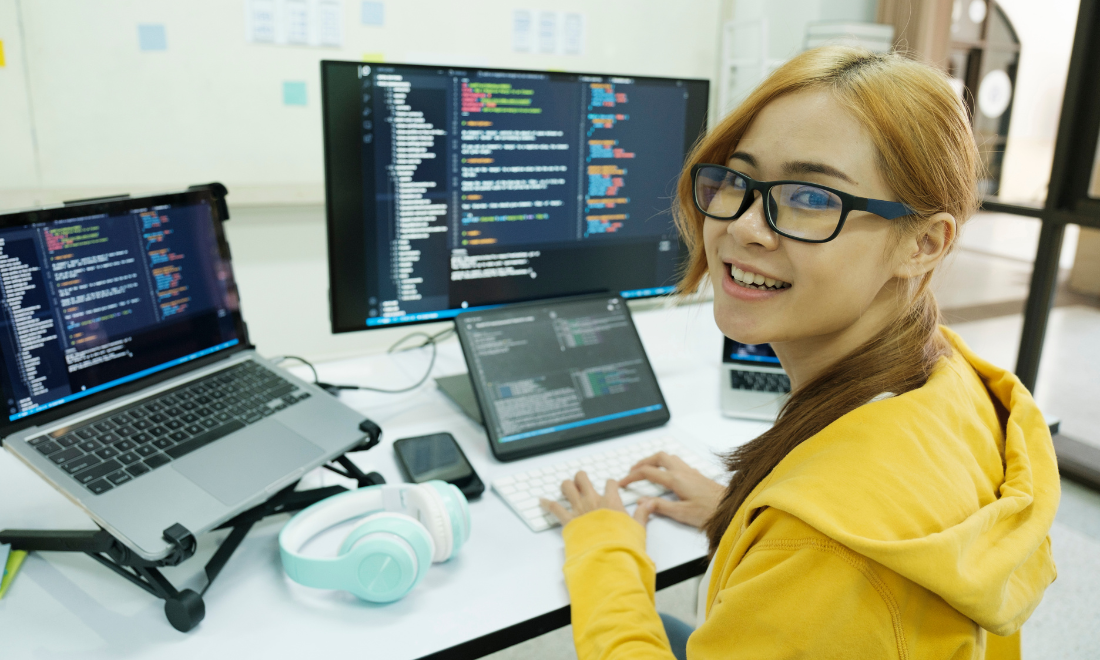 Remote AI model trainer working on her multi-screen computer setup