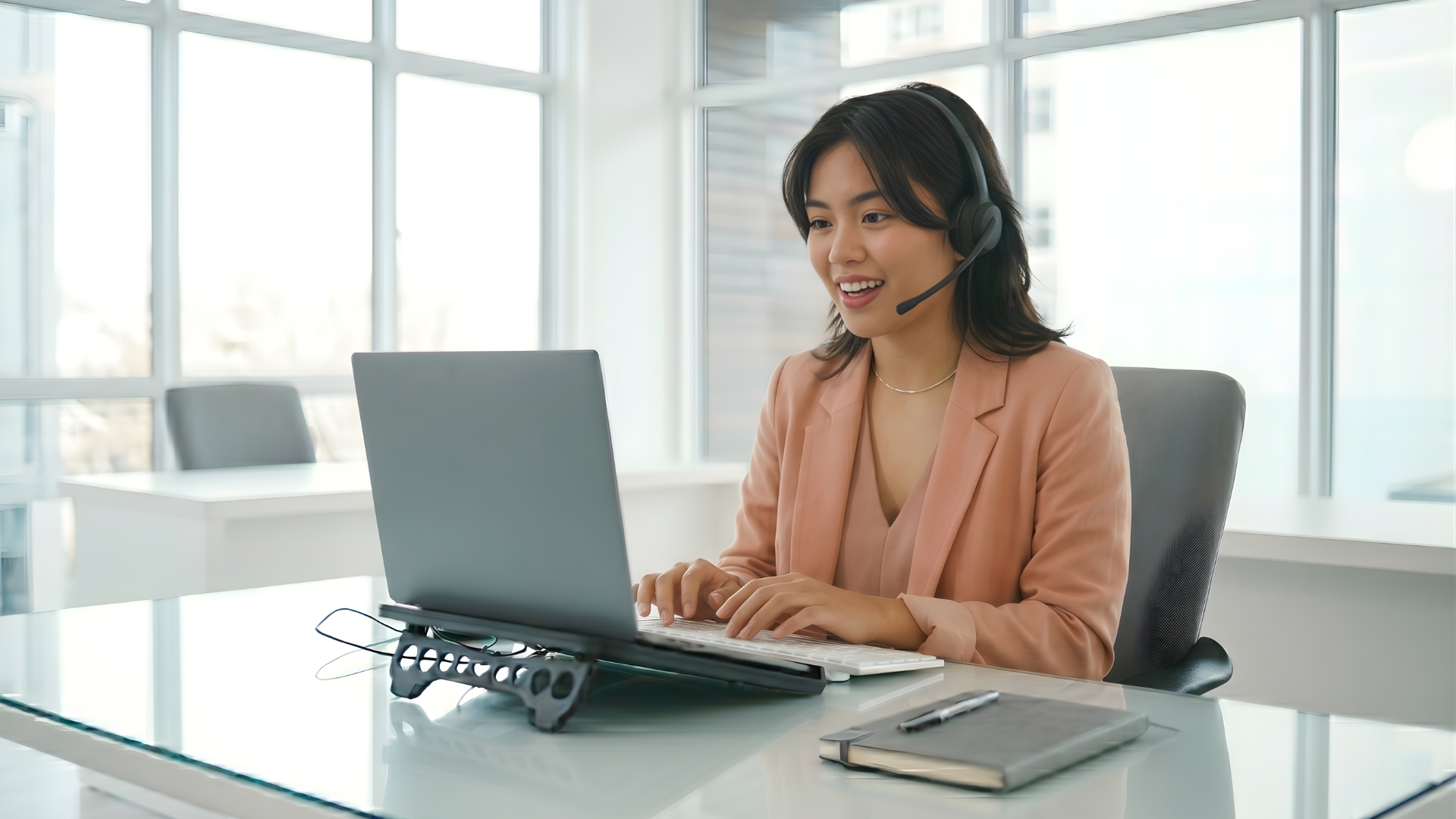 remote service desk analyst working with a laptop in an office