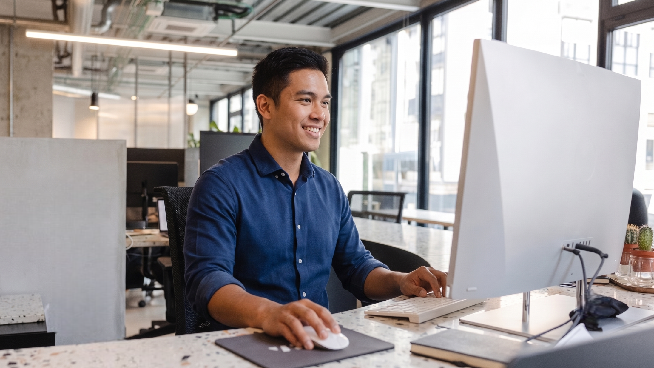 filipino remote security consultant working in a corporate it office with a computer