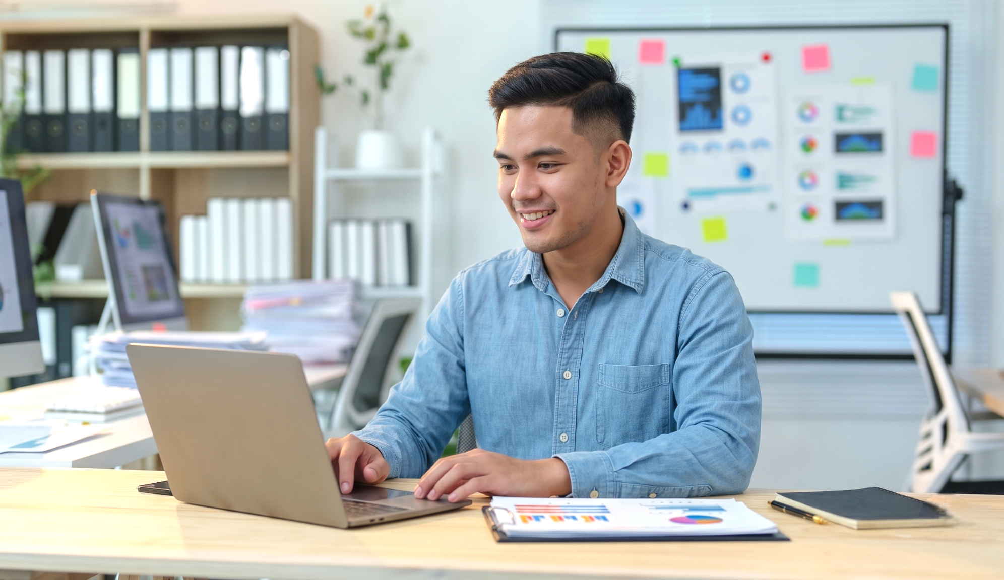 A remote scrum master working on a laptop from an office.