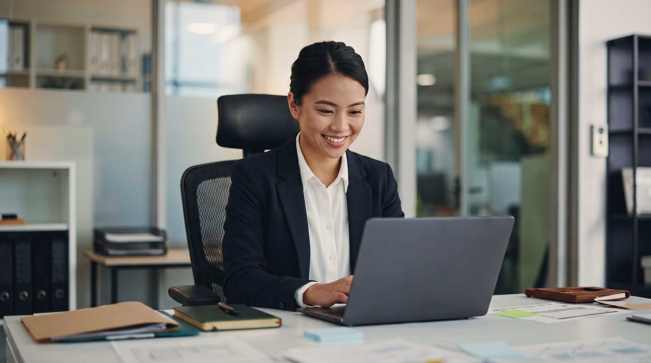 filipino remote tax associate preparing tax in an office with a laptop