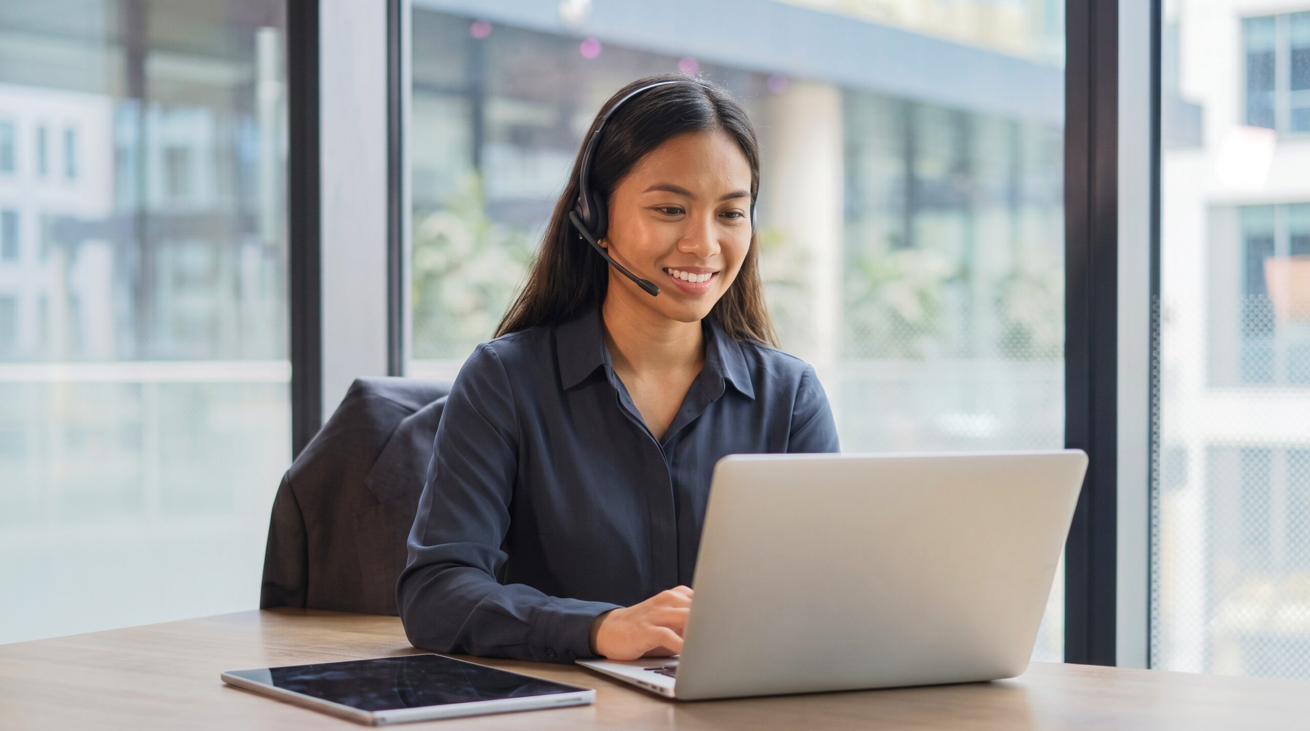 Remote onboarding account manager conducting a virtual client call at her office desk